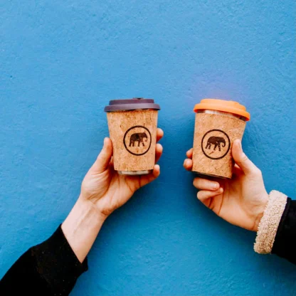 holding two Elephant coffee cups